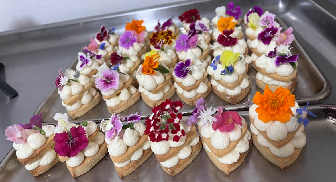 Cream biscuits with edible flowers